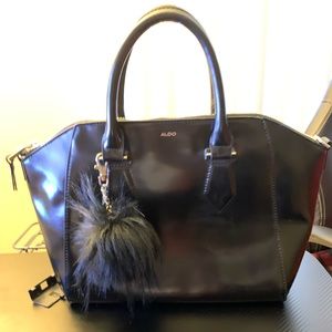 black aldo handbag w/ fur ball detail